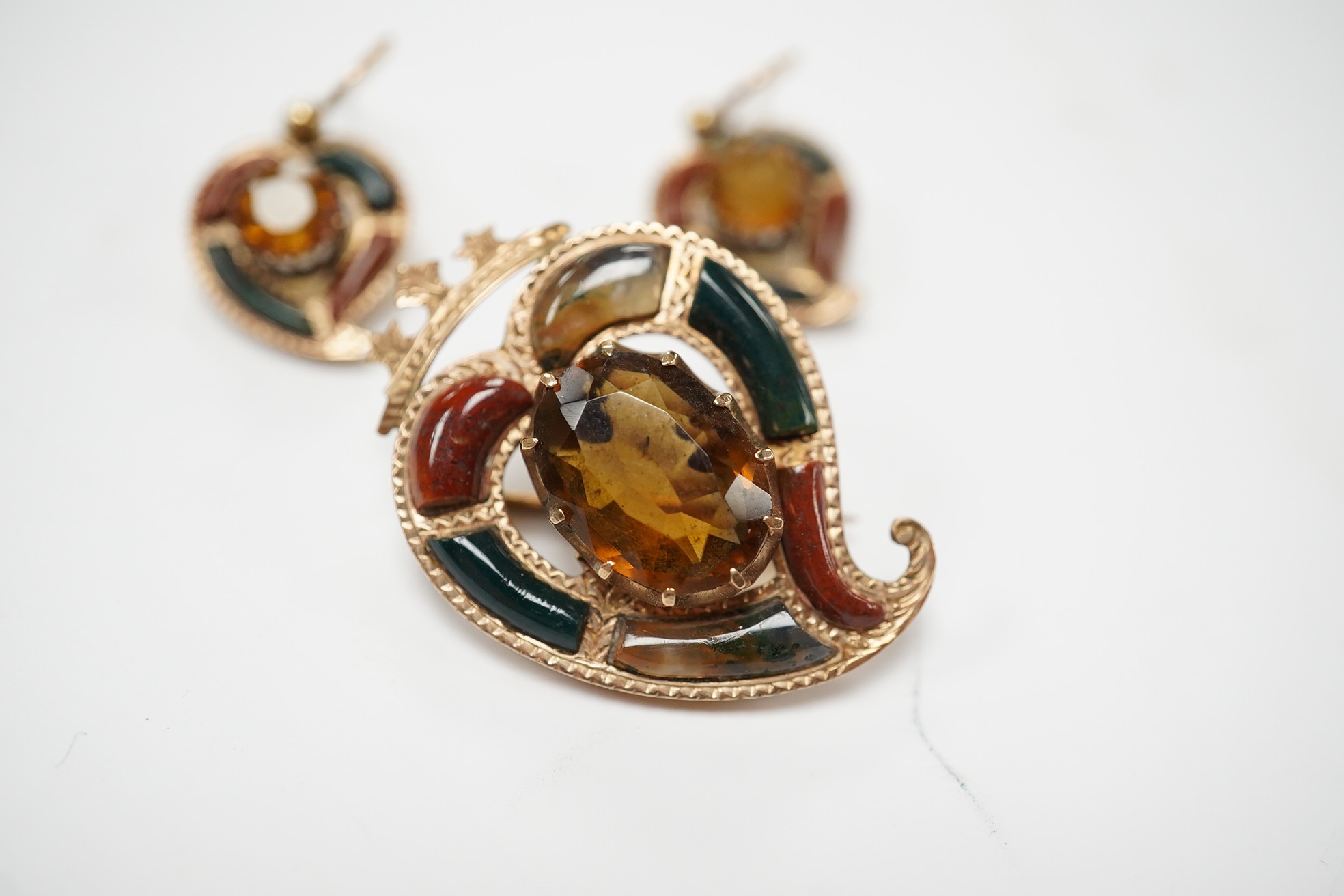 A yellow metal, Scottish hardstone and citrine set suite of jewellery, comprising a brooch, 30mm and pair of earrings, gross weight 7 grams. Condition - fair